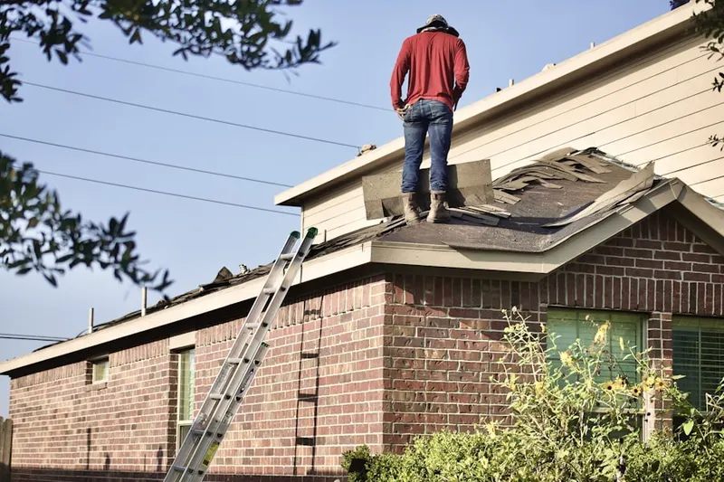 Professional roofer working on a residential roof in Kuhrs Lane